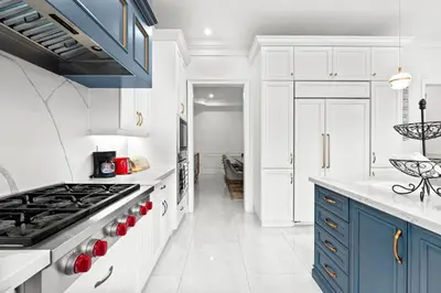 a kitchen with white cabinets and blue appliances at GlobalStay Luxury 4 Bedroom House Wonderland Vaughan in Vaughan