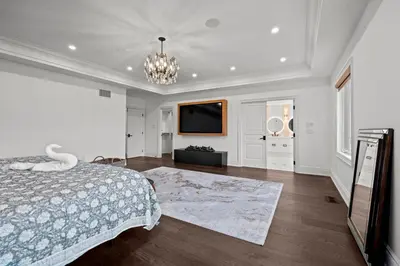 a bedroom with a bed and a flat screen tv at GlobalStay Luxury 4 Bedroom House Wonderland Vaughan in Vaughan