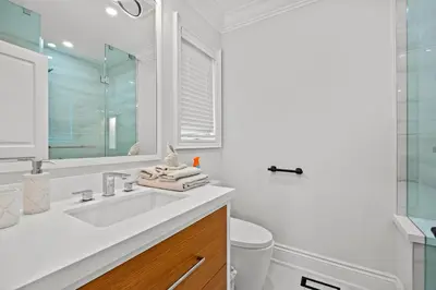 a white bathroom with a sink and a mirror at GlobalStay Luxury 4 Bedroom House Wonderland Vaughan in Vaughan