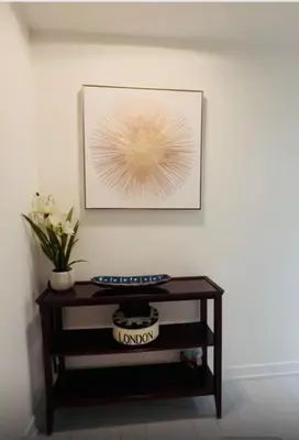 a picture on a wall above a table with a plant at Spectacular Large 3 Bedroom 3 Bath Condo Downtown Toronto Lakeview in Toronto