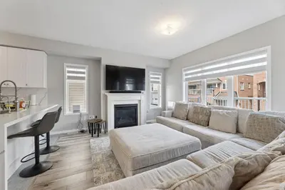 a living room with a couch and a fireplace at The Devineridge Executive House in Ajax