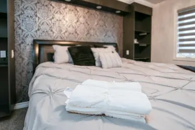 a large white bed with white towels on it at Comfy 3 Bed woodstock Escape in Woodstock
