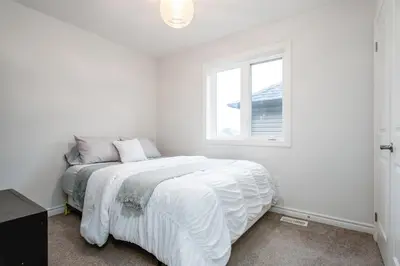 a white bedroom with a bed and a window at Comfy 3 Bed woodstock Escape in Woodstock