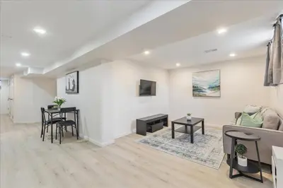 a living room with a couch and a table at Stewarts Place Newly Renovated Basement City Apartment in Hamilton