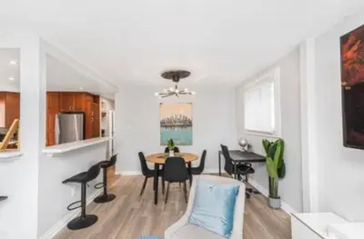 a kitchen and dining room with a table and chairs at Quaint and Stylish UPPER level 3-bed bungalow in Hamilton, ON in Hamilton