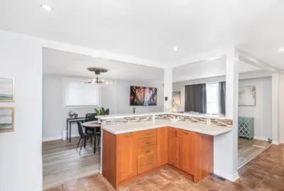 a kitchen with a counter top and a dining room at Quaint and Stylish UPPER level 3-bed bungalow in Hamilton, ON in Hamilton