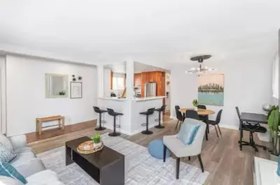 a living room with a couch and a table at Quaint and Stylish UPPER level 3-bed bungalow in Hamilton, ON in Hamilton