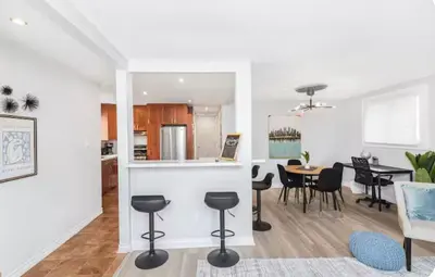 a kitchen and living room with a table and chairs at Quaint and Stylish UPPER level 3-bed bungalow in Hamilton, ON in Hamilton