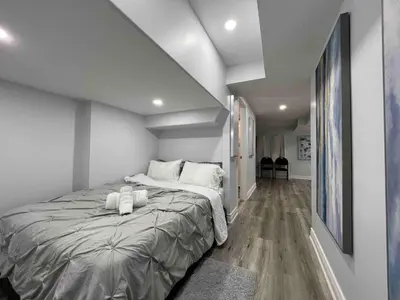 a bedroom with a large bed with white pillows at Elegant Oakville Town Residece in Oakville