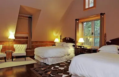 a hotel room with two beds and a window at Eganridge Resort, Golf Club & Spa in Bobcaygeon