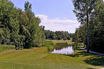 a view of a golf course with a pond at Eganridge Resort, Golf Club & Spa in Bobcaygeon