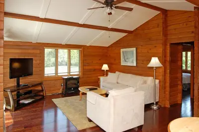 a living room with a white couch and a tv at Eganridge Resort, Golf Club & Spa in Bobcaygeon