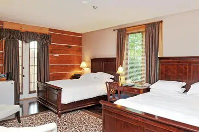 a hotel room with two beds and a window at Eganridge Resort, Golf Club & Spa in Bobcaygeon