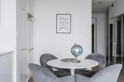a dining room with a white table and chairs at Downtown Toronto luxury condos in Toronto