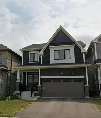 a large black house with a garage at New 3 Bedroom 2 Bathroom Home in West Niagara in Thorold