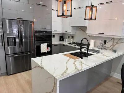 a kitchen with a marble counter top and stainless steel appliances at The Millertime Experience in Brantford