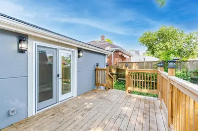 a wooden deck with a sliding glass door at The Millertime Experience in Brantford