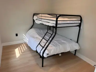a bedroom with two bunk beds in a room at The Millertime Experience in Brantford