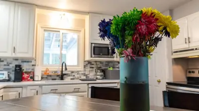a vase filled with colorful flowers on a kitchen counter at R&R Heaven Music 4 the Soul See fall colors Hottub in Campbellford