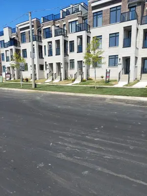 an empty street in front of an apartment building at Bowmanville Room in Bowmanville