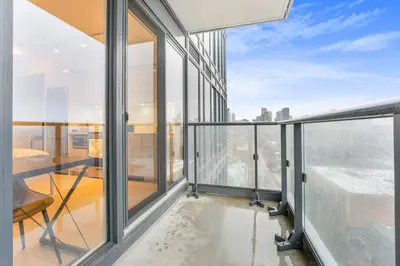 a balcony with glass doors and a view of the city at 251 Jarvis st -Steps to Eaton Centre - Monthly Stays Only in Toronto