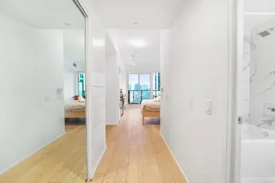 a white bathroom with a tub and a sink at 251 Jarvis st -Steps to Eaton Centre - Monthly Stays Only in Toronto