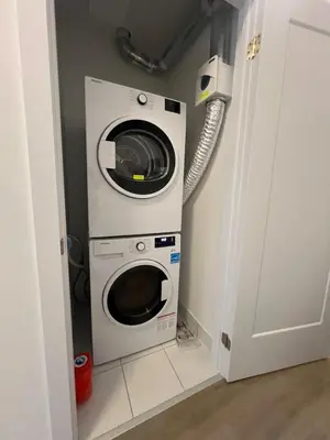 a washing machine and a dryer in a room at Stylish 2-Story Condo with Balcony in Kitchener
