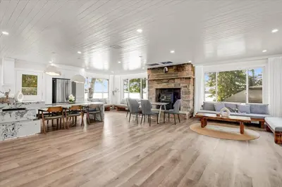 a living room with a fireplace and a dining room at Pet friendly- Crystal Water fishing Family Retreat in Havelock
