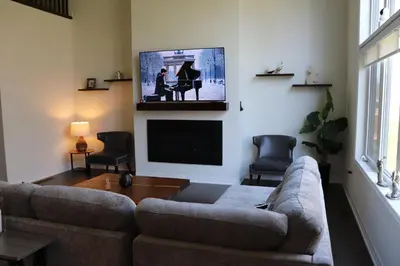a living room with a couch and a flat screen tv at Severn Woodland in Severn