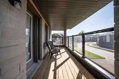 a porch with a chair sitting on a balcony at Severn Woodland in Severn