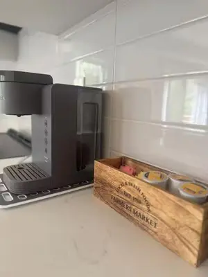 a kitchen with a microwave and a wooden box at Severn Woodland in Severn