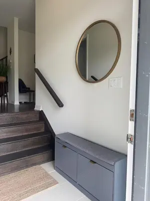 a mirror on a wall next to a staircase at Severn Woodland in Severn
