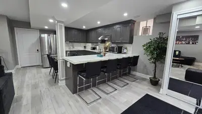 a kitchen with a island in the middle of a room at 3 bdrm 3 bath bsmt Brampton Toronto, Sleeps 16 in Brampton