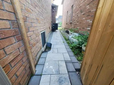 an alley between two brick buildings with a door at 3 bdrm 3 bath bsmt Brampton Toronto, Sleeps 16 in Brampton