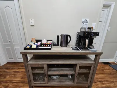 a table with a coffee maker on top of it at King Comfort Retreat in Peterborough