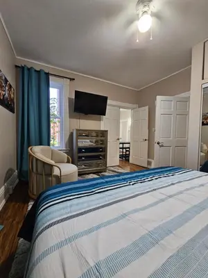 a bedroom with a bed and a flat screen tv at King Comfort Retreat in Peterborough