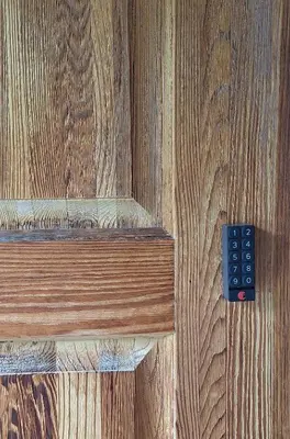 a wooden door with a remote control on it at Century House on Quarter acre lot in Acton