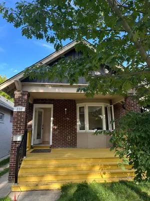 a home with a porch and a brick house at Toronto Upper Beaches Apartment in Toronto