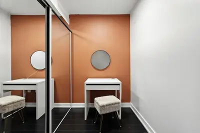 a dressing room with two mirrors and two stools at Stylish DT Condo with Vanity Mirror, Free Parking! in Toronto