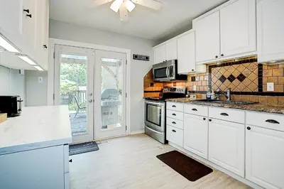 a kitchen with white cabinets and white appliances at Winter Family Retreat-Snow Play & Ski Hills Nearby in Barrie