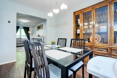 a dining room with a black table and chairs at Winter Family Retreat-Snow Play & Ski Hills Nearby in Barrie