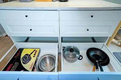 a drawer in a kitchen with two pans and a pan at Winter Family Retreat-Snow Play & Ski Hills Nearby in Barrie