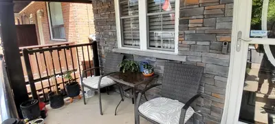 a patio with a table and chairs on a balcony at The Cozy Bungalow in North York Nest in Toronto