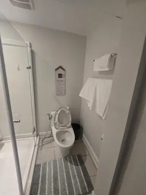 a small bathroom with a toilet and towels at Private in Mississauga
