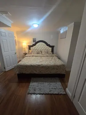 a bedroom with a bed in a room with a door at Private in Mississauga