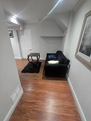 a living room with a couch and a table at Private in Mississauga