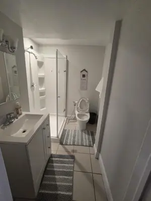 a white bathroom with a toilet and a sink at Private in Mississauga