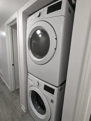 a washing machine and a dryer in a room at Bright & New 2 Beds Near Subway in Toronto