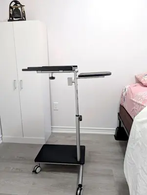a table in a room next to a bed at Bright & New 2 Beds Near Subway in Toronto