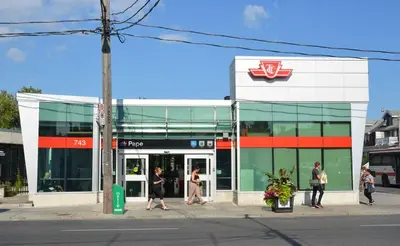 people walking outside of a store on the street at Bright & New 2 Beds Near Subway in Toronto